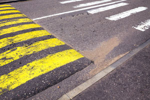 pedestrian crosswalk and yellow-striped speed bump